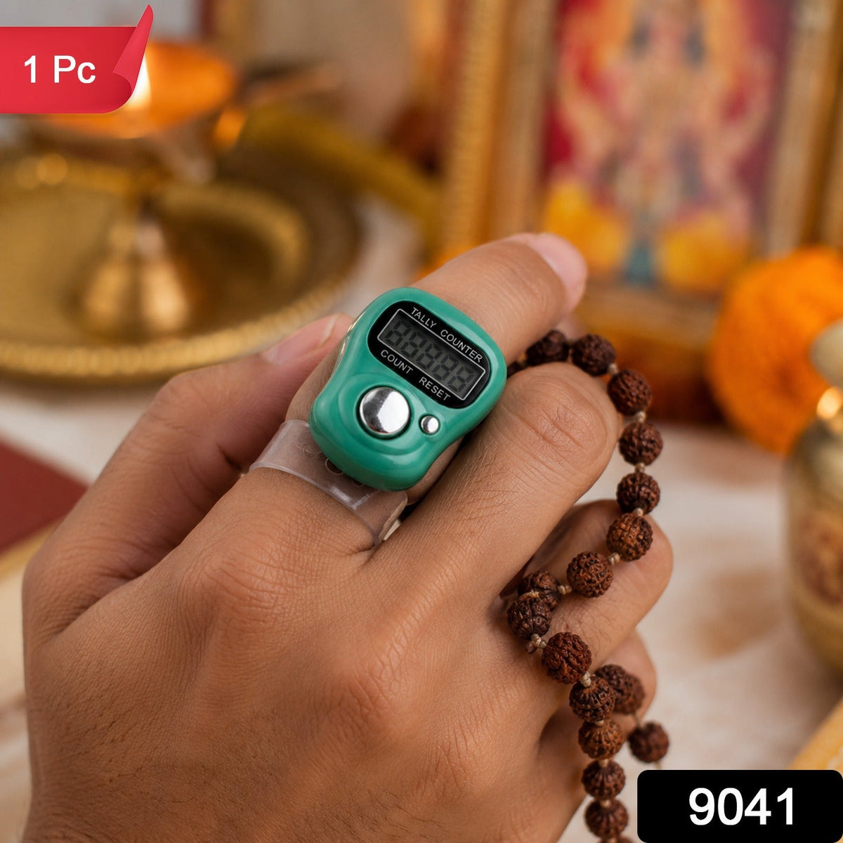 A hand holds a green digital tally counter on a finger, with brown prayer beads. A red "1 Pc" label is in the top left