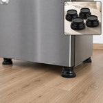 Four black plastic support legs elevating a stainless steel refrigerator on a wooden floor, with an inset showing the legs