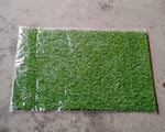 Display of the soft and durable 58x38cm plastic grass, suitable for indoor and outdoor use.