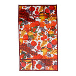 A flat lay of the fruit-patterned refrigerator top cover, showcasing its full design and pockets.