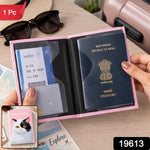 A person's hands display an open pink passport holder with a passport and boarding pass, with a small inset showing the