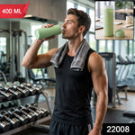 A man in a gym drinking from a light green glass water bottle with a silicone sleeve. Inset shows the bottle on a desk. Red