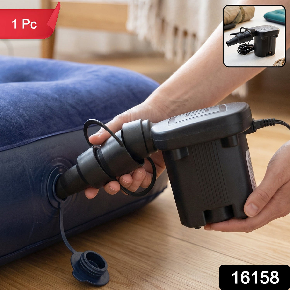 Close-up of a black electric air pump with three nozzles, inflating a blue air mattress, with hands holding it.