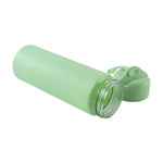 A light green glass water bottle with a silicone sleeve lying on its side, with the cap detached and lying next to it.