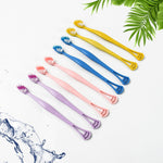 Close-up of the dual-action head of the toothbrush with soft bristles and integrated tongue scraper.