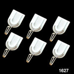 Close-up of a white plastic self-adhesive hook on a wall.