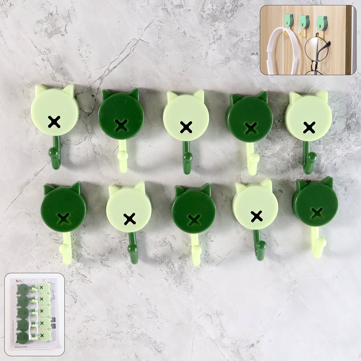 Ten cat-shaped wall hooks in dark and light green against a grey marble background, with an inset of the hooks in – view 7