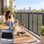 A woman and child on a balcony with a black mesh safety net installed on the railing, city skyline behind them.