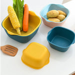 Plastic washing bowl and strainer basket displayed on a kitchen counter.