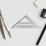 A carpenter using the versatile 45-degree triangle ruler for framing, ensuring accurate cuts.