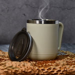A sleek stainless steel coffee mug with an ergonomic handle.