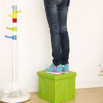 The foldable cube ottoman disassembled, illustrating its space-saving design for easy storage.