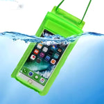 A green waterproof phone case with a smartphone inside is partially submerged in clear blue water, showing water splashing