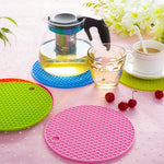 Round heat-resistant silicone trivet with a non-slip design.