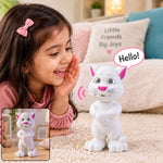 A young girl in a pink shirt smiles at a white cat toy with pink ears and nose, saying "Hello!" in a speech bubble, – view 9