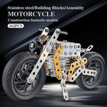 Child engaged in building the metal bike model, an educational STEM toy.