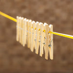 Sturdy bamboo wooden cloth clips with stainless steel springs, ready for household use.
