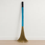 Close-up view of floor broom head with synthetic bristles