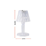 A modern mini crystal table lamp glowing softly in a contemporary interior.