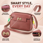 A mauve sling bag with a gold bow and colorful charms, highlighting multiple zip pockets and crossbody comfort.