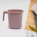 Four square bath mugs in transparent mixed colors, stacked neatly.