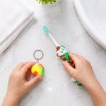 Side view of kids toothbrush and toy ball set packaging with bright design