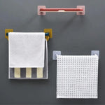 Multifunctional folding towel shelf used in a kitchen for dishcloths and utensils.