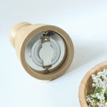 Traditional wooden pepper grinder featuring hand twist mechanism for freshness