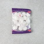 Close-up image of round naphthalene mothball tablets for wardrobe freshness