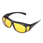 A single pair of black wrap-around glasses with yellow lenses, viewed from the front-right, on a white background.