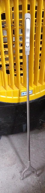 The garbage picker tool shown in use, making rubbish pickup effortless.