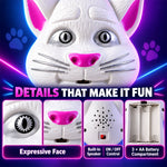 Close-up details of the white cat toy's face, showing an expressive eye, pink nose, speaker, on/off control, and battery