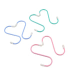 Three colorful plastic coated S hooks in blue, green, and pink on a white background.
