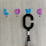 Decorative love shape self adhesive hooks enhancing room aesthetics.