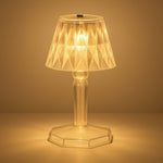 A detailed view of the acrylic crystal table lamp on a wooden surface.