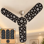 A ceiling fan with black and white floral dust covers installed, with an inset showing the four covers on a wooden surface.