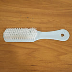 Close-up of ergonomic handle and bristles on handheld cleaning brush