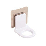 Self-adhesive hook securely holding shampoo and body wash bottles in a shower.