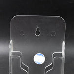 Durable ABS mobile holder securely displaying a phone on a bedroom wall.