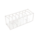 An empty white mesh organizer with seven compartments is angled on a clean white background.