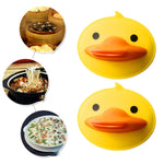 Bright yellow silicone duck-shaped pot holder in practical use
