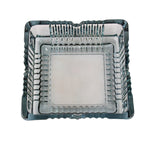 The elegant square glass ashtray displayed in a home or office setting.