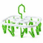 A white square drying rack with green plastic clips and a green hook on a plain white background.