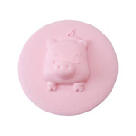 Silicone drain cover with pig design presented on a clean white background.