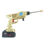 The complete gold and black pressure washer kit with two batteries, hose, charger, and various nozzles on a patio.