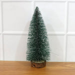 Miniature green Christmas tree with snow effect and sturdy wooden base for festive decor