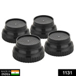 Set of four round black plastic furniture leg risers, ready for installation.