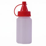 A small, empty, white ribbed plastic squeeze bottle with a bright red cap stands against a plain white background.