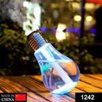 A single blue bulb-shaped humidifier with palm trees inside emits mist on a wooden surface.