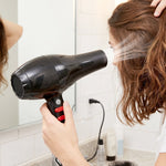 Woman styling her hair effortlessly with the portable hair dryer.